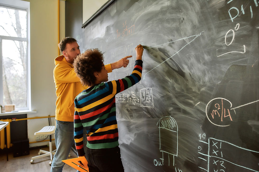 A tutor writing a maths formula on a whiteboard
